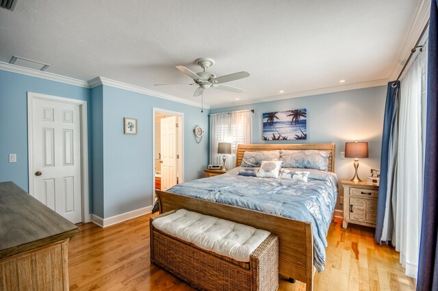 bedroom featuring light wood-style floors, attic access, ornamental molding, and baseboards