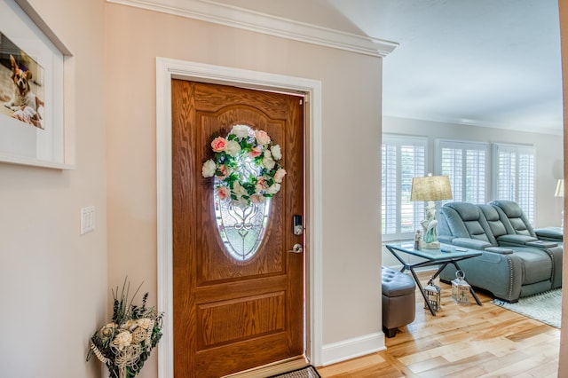 entryway with baseboards, wood finished floors, and crown molding