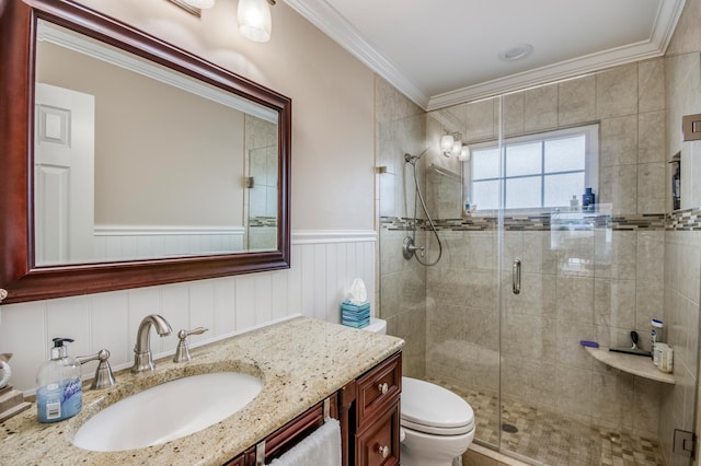 bathroom with ornamental molding, wainscoting, a shower stall, and toilet