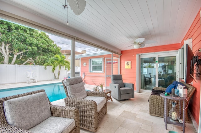 view of patio / terrace with ceiling fan, fence, and a fenced in pool