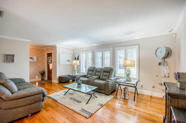 living room with ornamental molding, light wood finished floors, and baseboards