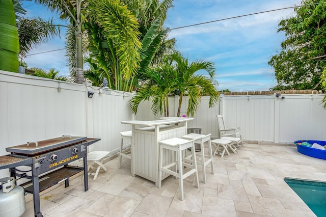 view of patio featuring outdoor dining space and a fenced backyard