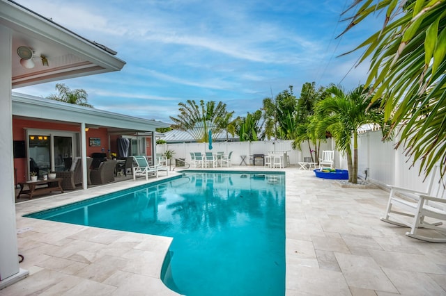 view of swimming pool with a patio area, a fenced backyard, and a fenced in pool