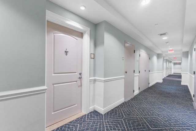 corridor with carpet, visible vents, baseboards, and recessed lighting