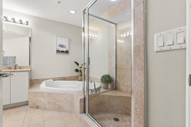 full bathroom with a shower stall, vanity, a bath, and tile patterned floors