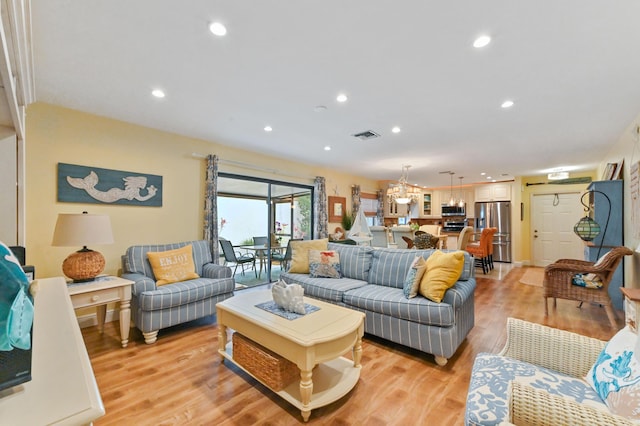 living area featuring visible vents, recessed lighting, and light wood-type flooring