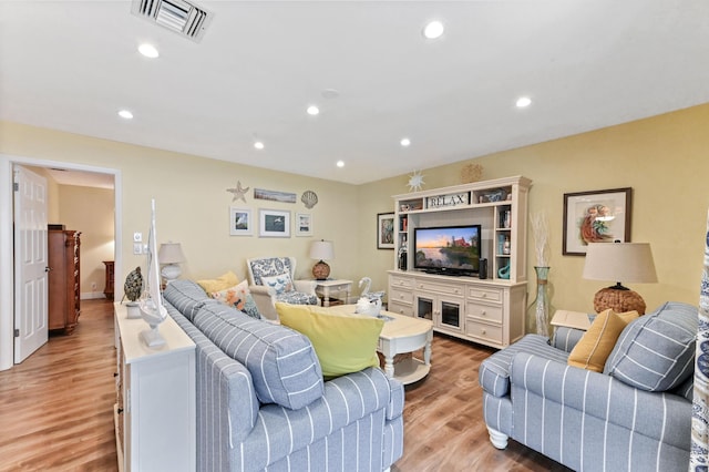 living room featuring recessed lighting, visible vents, and light wood-style floors