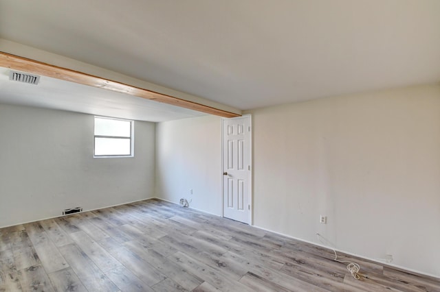 unfurnished room featuring visible vents and wood finished floors