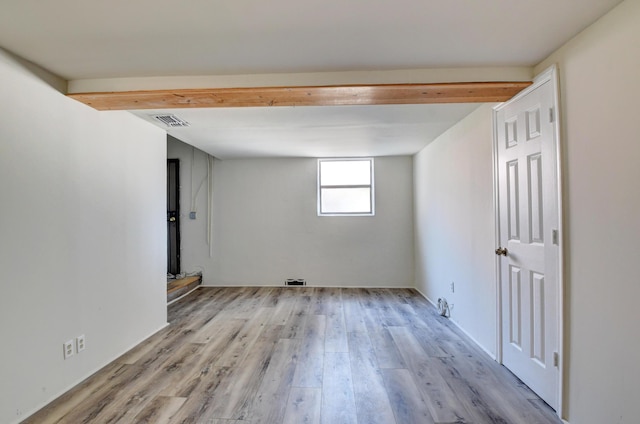 unfurnished room with visible vents and wood finished floors