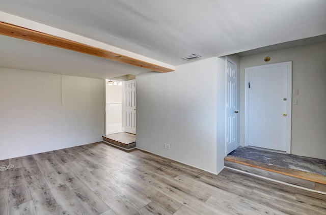 empty room featuring visible vents and wood finished floors