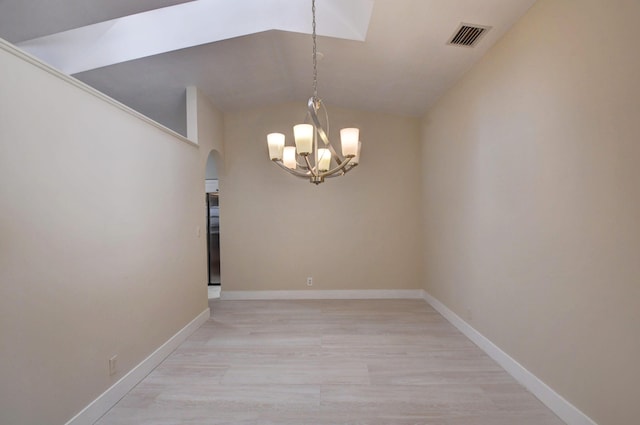 empty room featuring arched walkways, light wood-style flooring, visible vents, baseboards, and an inviting chandelier