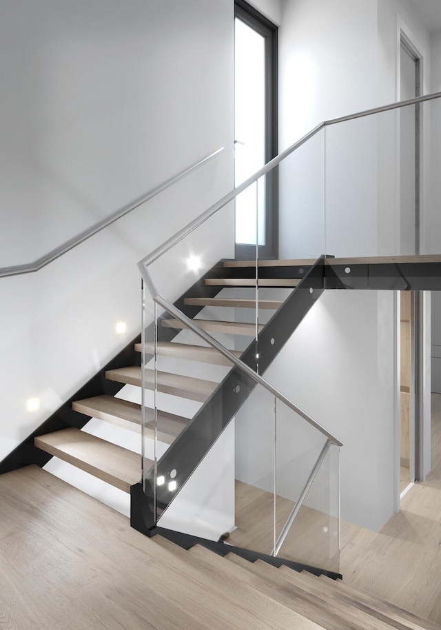 stairway with wood finished floors