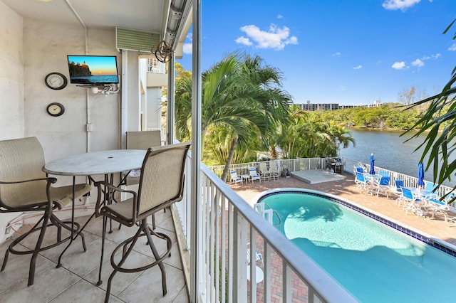 balcony featuring a patio area and a water view