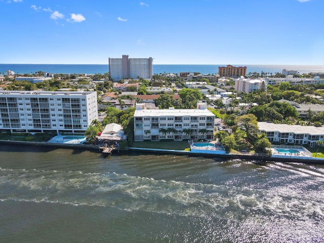 birds eye view of property featuring a city view and a water view