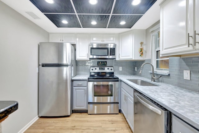 kitchen with visible vents, appliances with stainless steel finishes, light countertops, and a sink