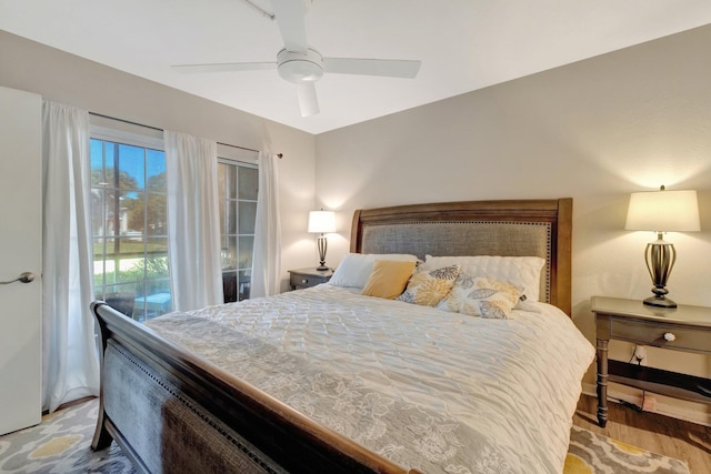 bedroom featuring access to exterior, wood finished floors, and ceiling fan