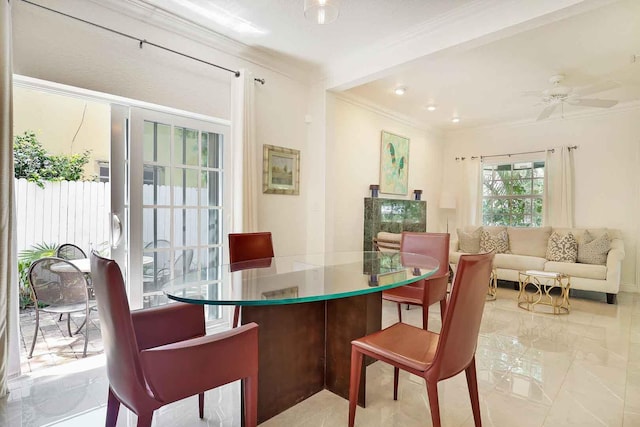 dining room with crown molding, marble finish floor, and ceiling fan