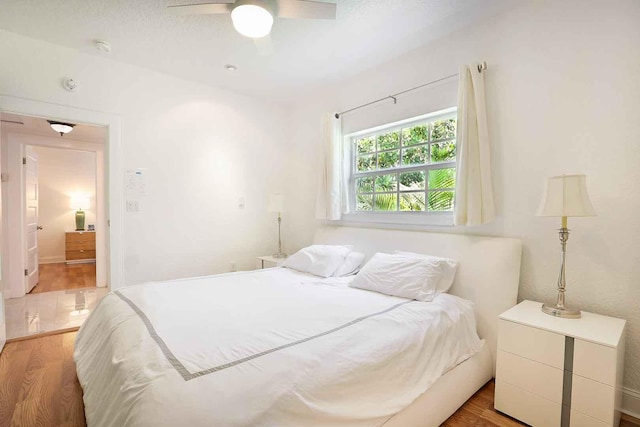 bedroom with a ceiling fan and wood finished floors