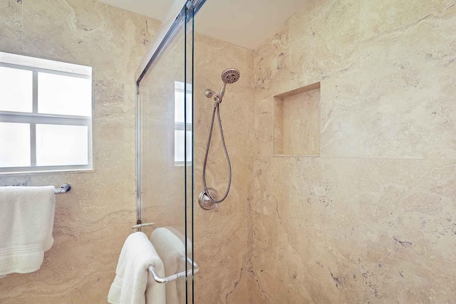 bathroom with a shower with door