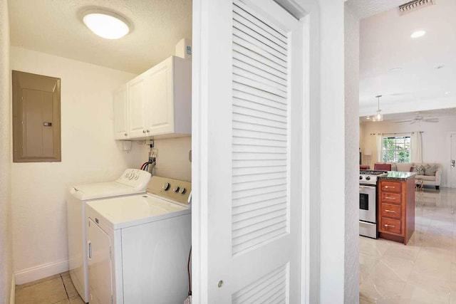 clothes washing area featuring visible vents, electric panel, cabinet space, ceiling fan, and washer and dryer