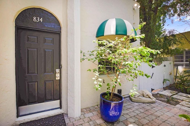 doorway to property with stucco siding