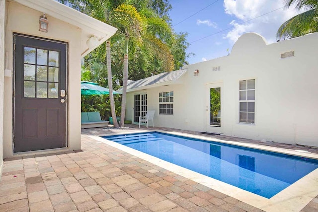 outdoor pool with a patio area