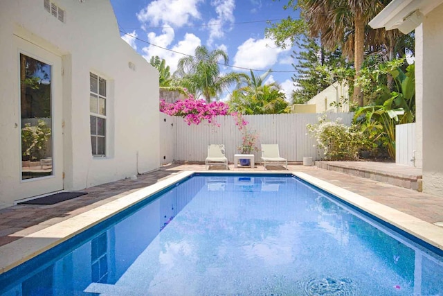 view of pool featuring a patio area, a fenced in pool, and a fenced backyard