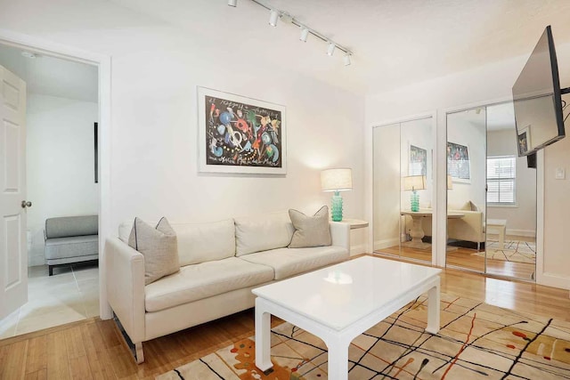 living room with baseboards and light wood-style flooring