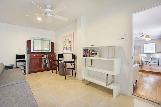 interior space featuring light tile patterned floors and a ceiling fan