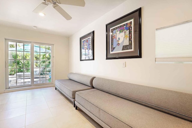 living area featuring light tile patterned floors and a ceiling fan