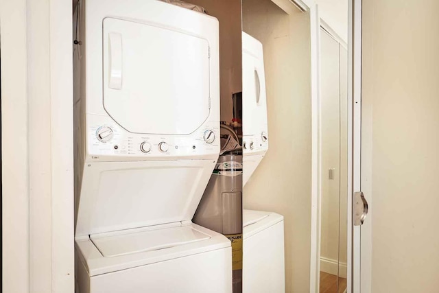 washroom featuring laundry area and stacked washer / drying machine