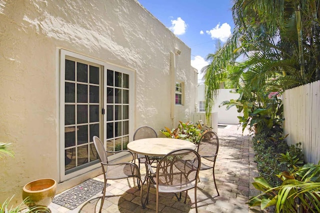 view of patio / terrace featuring french doors, a fenced backyard, and outdoor dining space