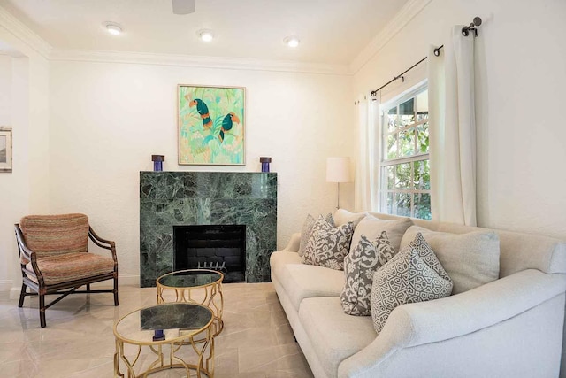 living area featuring a fireplace, crown molding, and baseboards