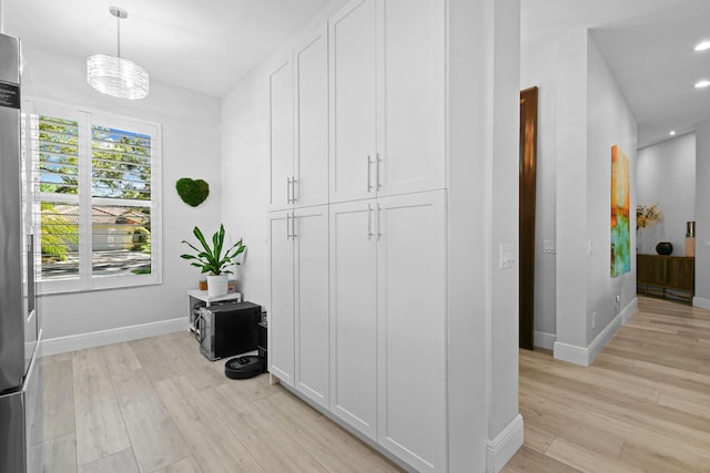 corridor with recessed lighting, baseboards, and light wood-type flooring