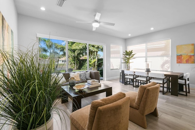 living area featuring a ceiling fan, visible vents, light wood finished floors, baseboards, and recessed lighting