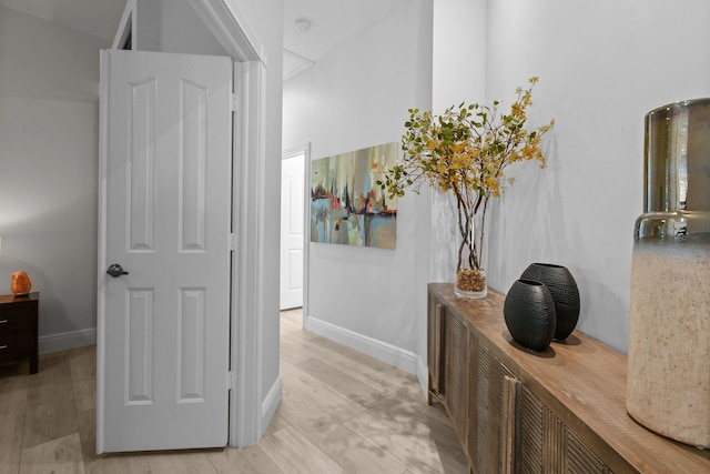 hallway with baseboards and light wood finished floors