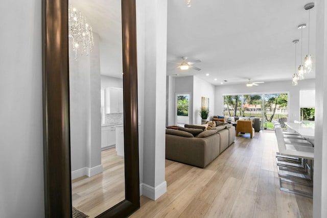 living room with light wood-style flooring, recessed lighting, and baseboards