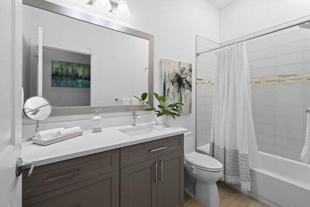 bathroom featuring vanity, toilet, wood finished floors, and shower / tub combo with curtain