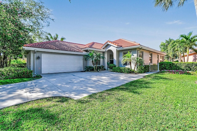 mediterranean / spanish-style home featuring stucco siding, driveway, an attached garage, and a tile roof