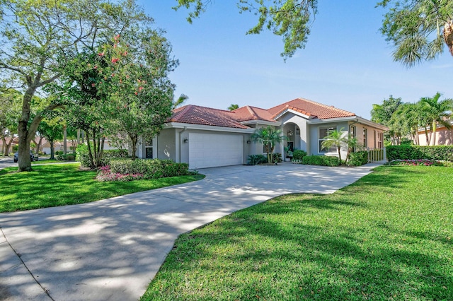 mediterranean / spanish-style home with a front lawn, a tile roof, concrete driveway, stucco siding, and a garage