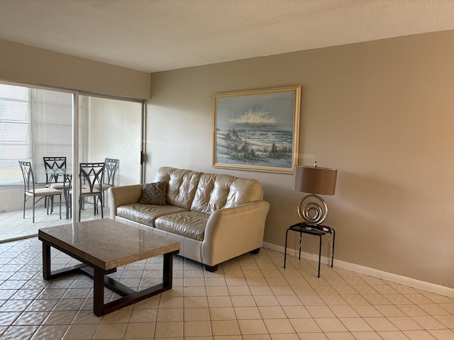 living room with baseboards and light tile patterned floors