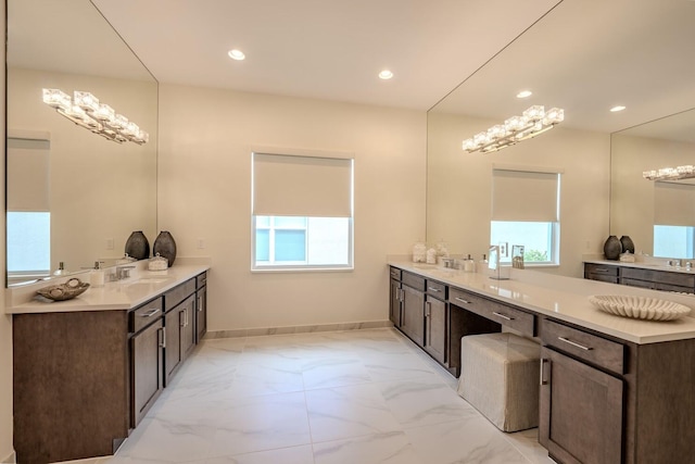 full bathroom with marble finish floor, baseboards, a sink, and recessed lighting