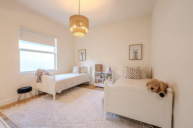 bedroom with baseboards and wood finished floors