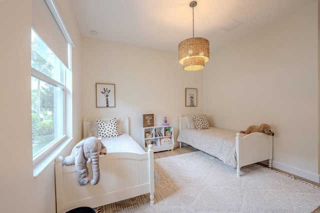 bedroom featuring baseboards and wood finished floors