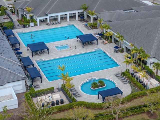 community pool featuring a gazebo, a patio area, and fence