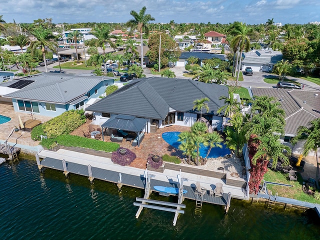 drone / aerial view featuring a water view and a residential view