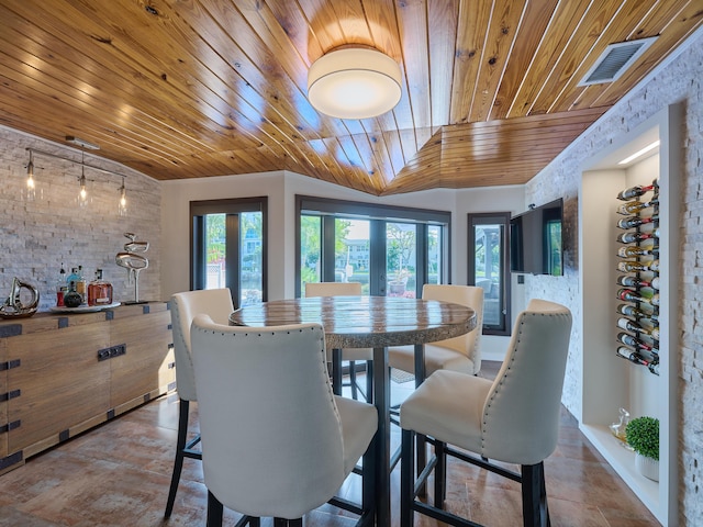 dining room featuring rail lighting, wood ceiling, and visible vents