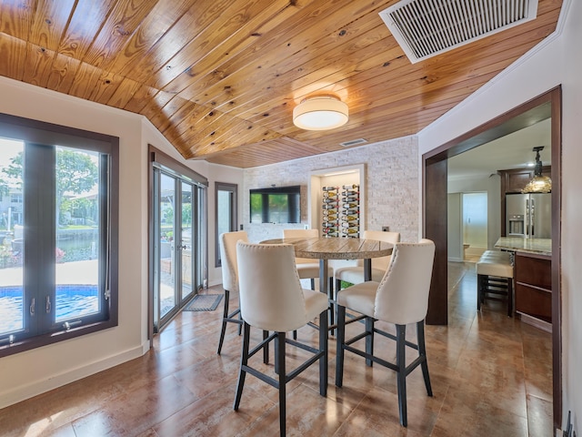 dining space with lofted ceiling, wood ceiling, visible vents, and baseboards