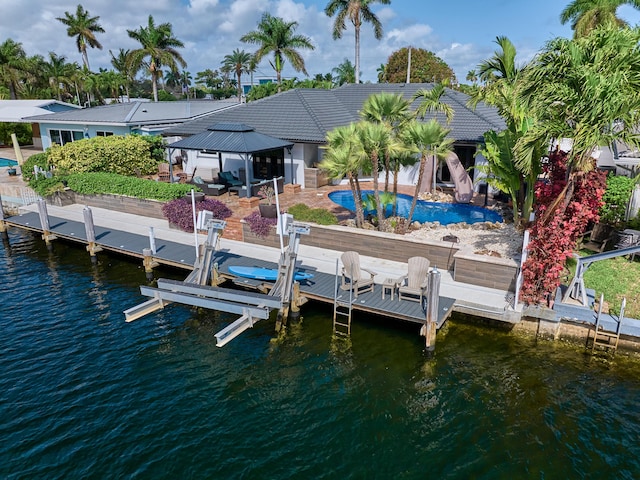 view of dock featuring a water view, boat lift, an outdoor pool, and a gazebo