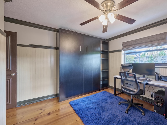 office area with light wood finished floors, ceiling fan, ornamental molding, and a textured ceiling